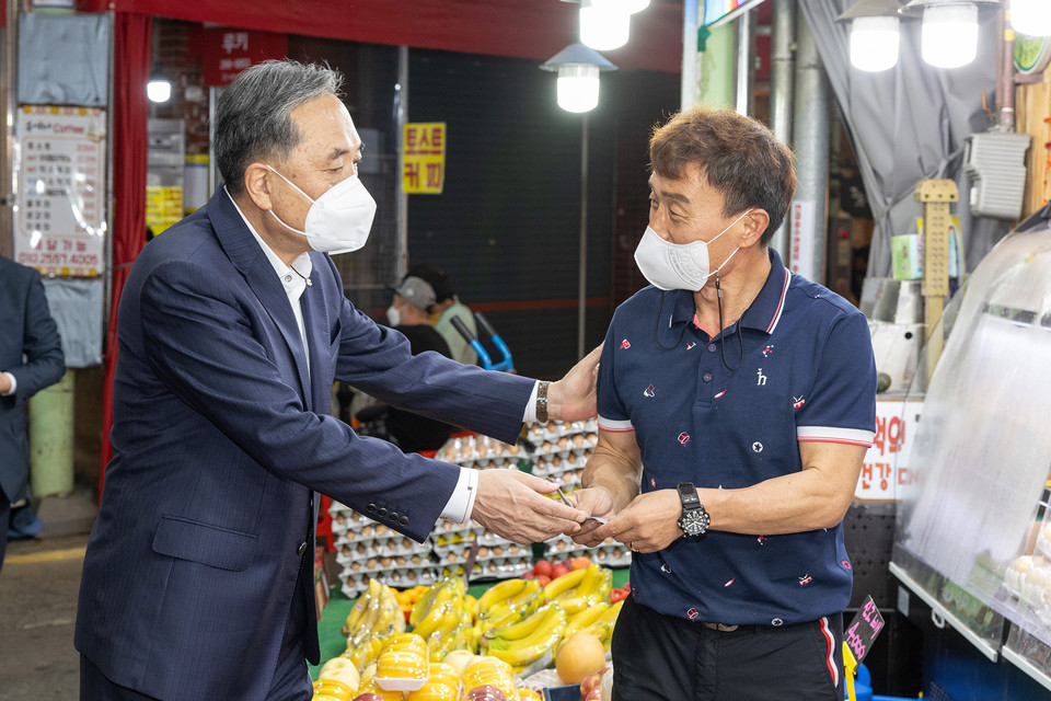 박차훈 새마을금고중앙회장이 울산신정시장에서 과일을 구매하며 상인과 담소를 나누고 있다